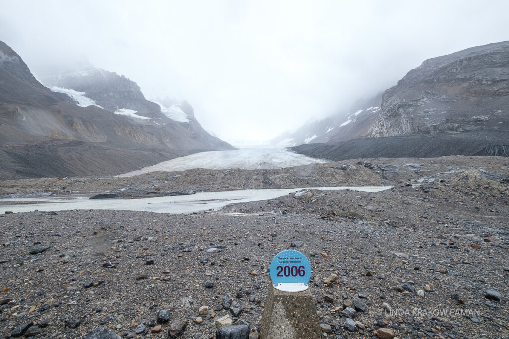 Another view of the glacier, this time with a sign in the foreground showing where the glacier was in 2006. 